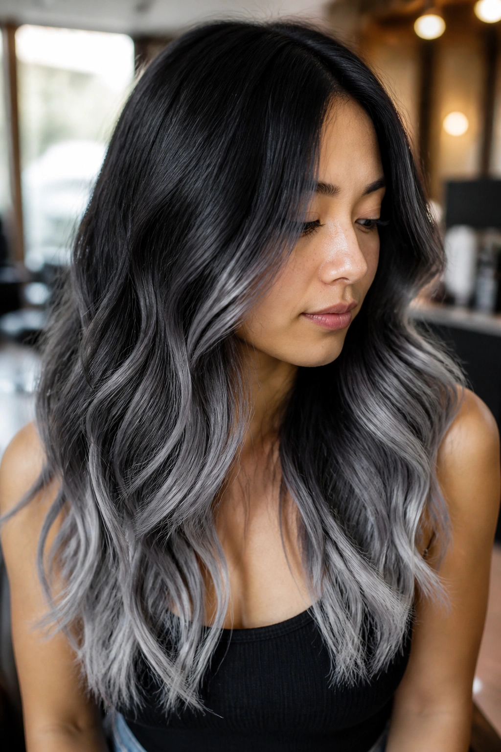 Close-up of a real woman with charcoal-to-silver three-step gradient on long hair