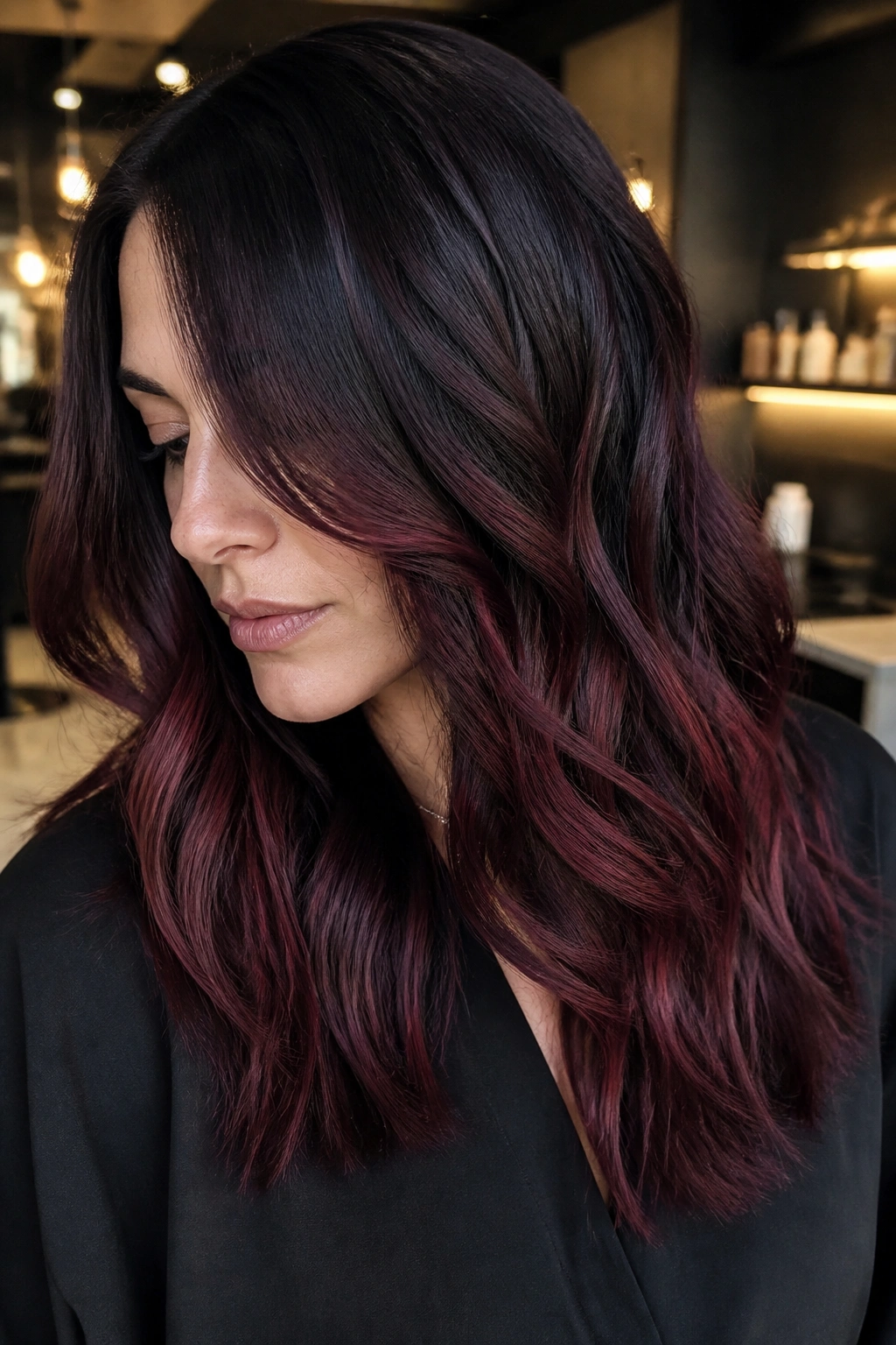 Close-up of cherry cola balayage on dark brown hair