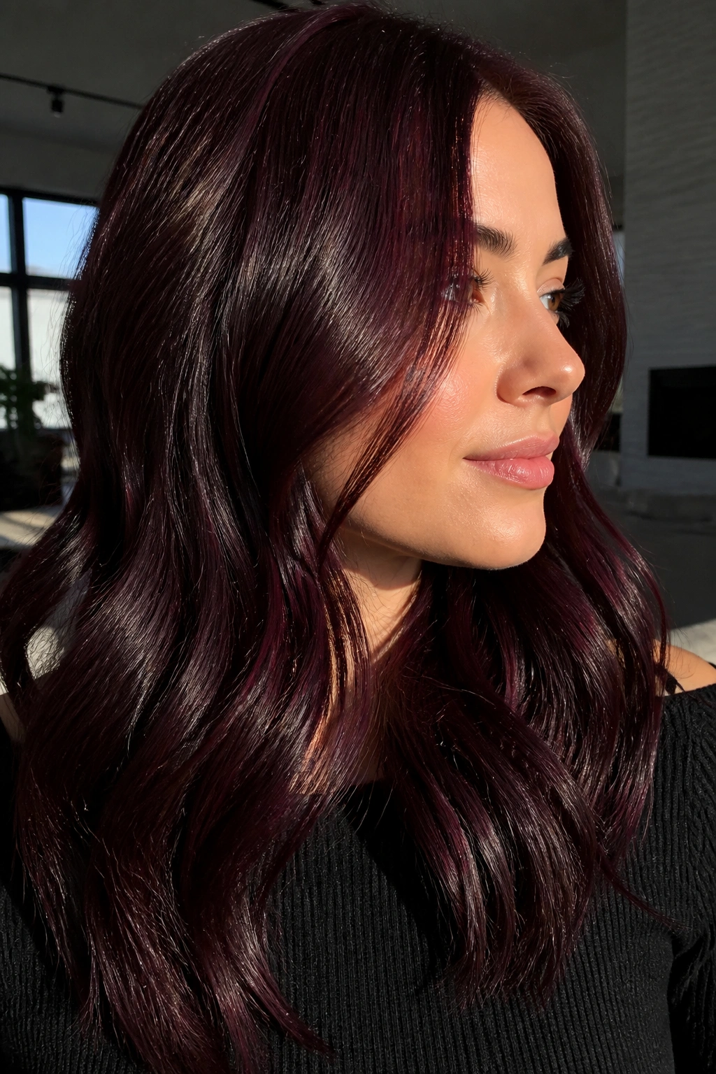 Portrait of cherry cola burgundy hair on a brunette with glossy finish
