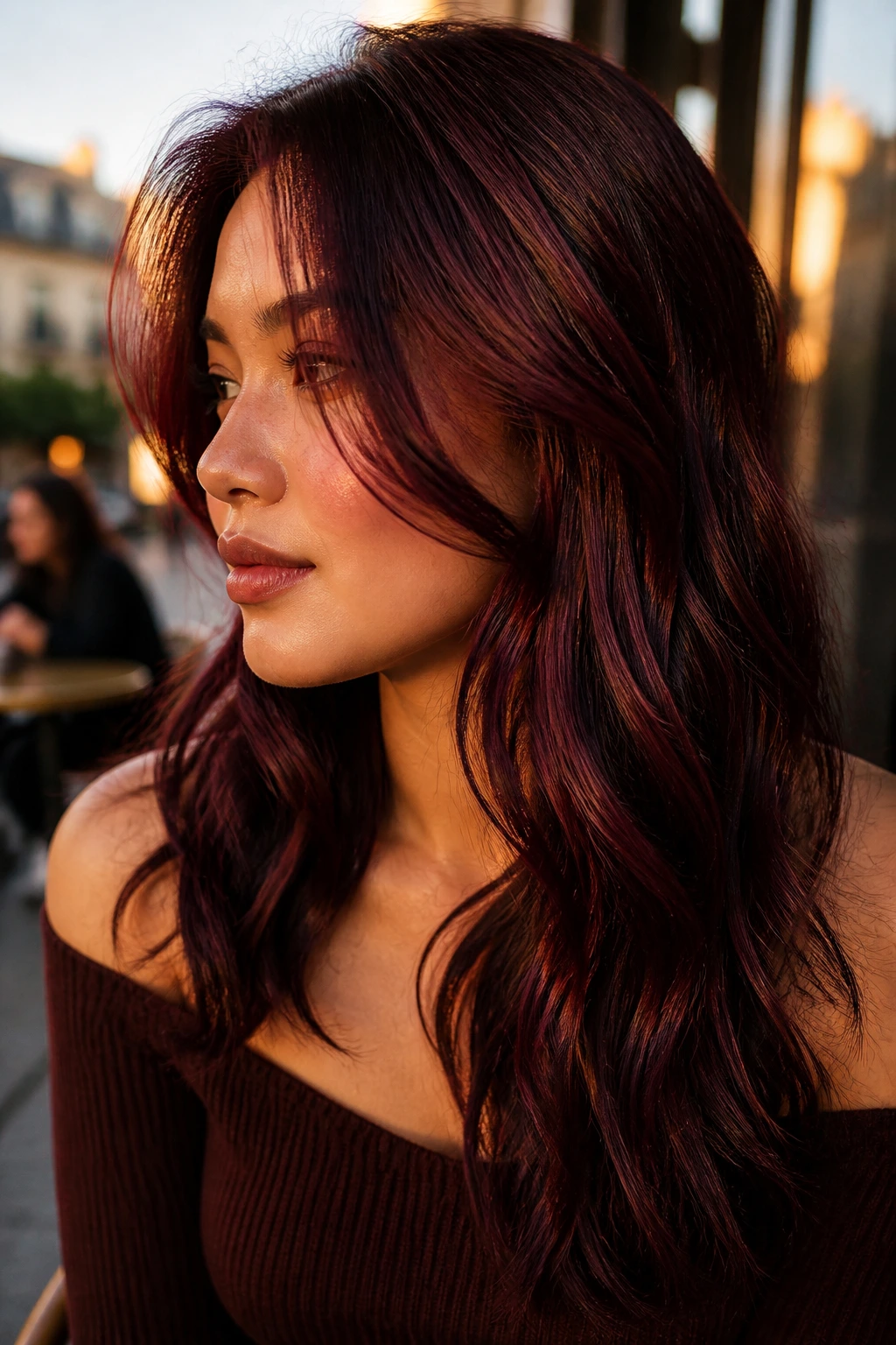 Close-up portrait of a woman with cherry cola dimension hair in golden hour outdoor setting