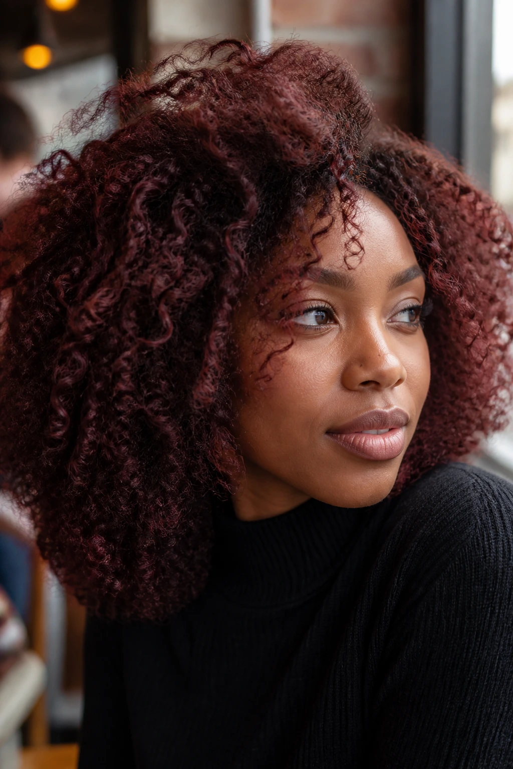 Close-up of a real person with deep brown hair featuring a red cherry cola tint.