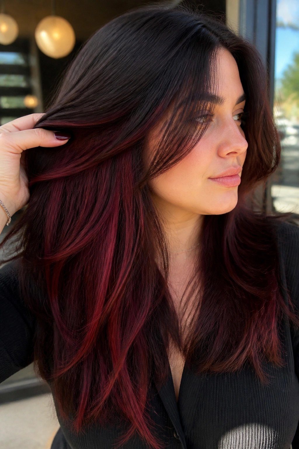 Close-up portrait showing cherry cola peekaboo highlights underneath darker top layers
