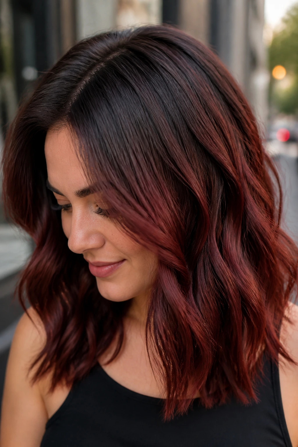 Close-up of a real woman with cherry mahogany root melt