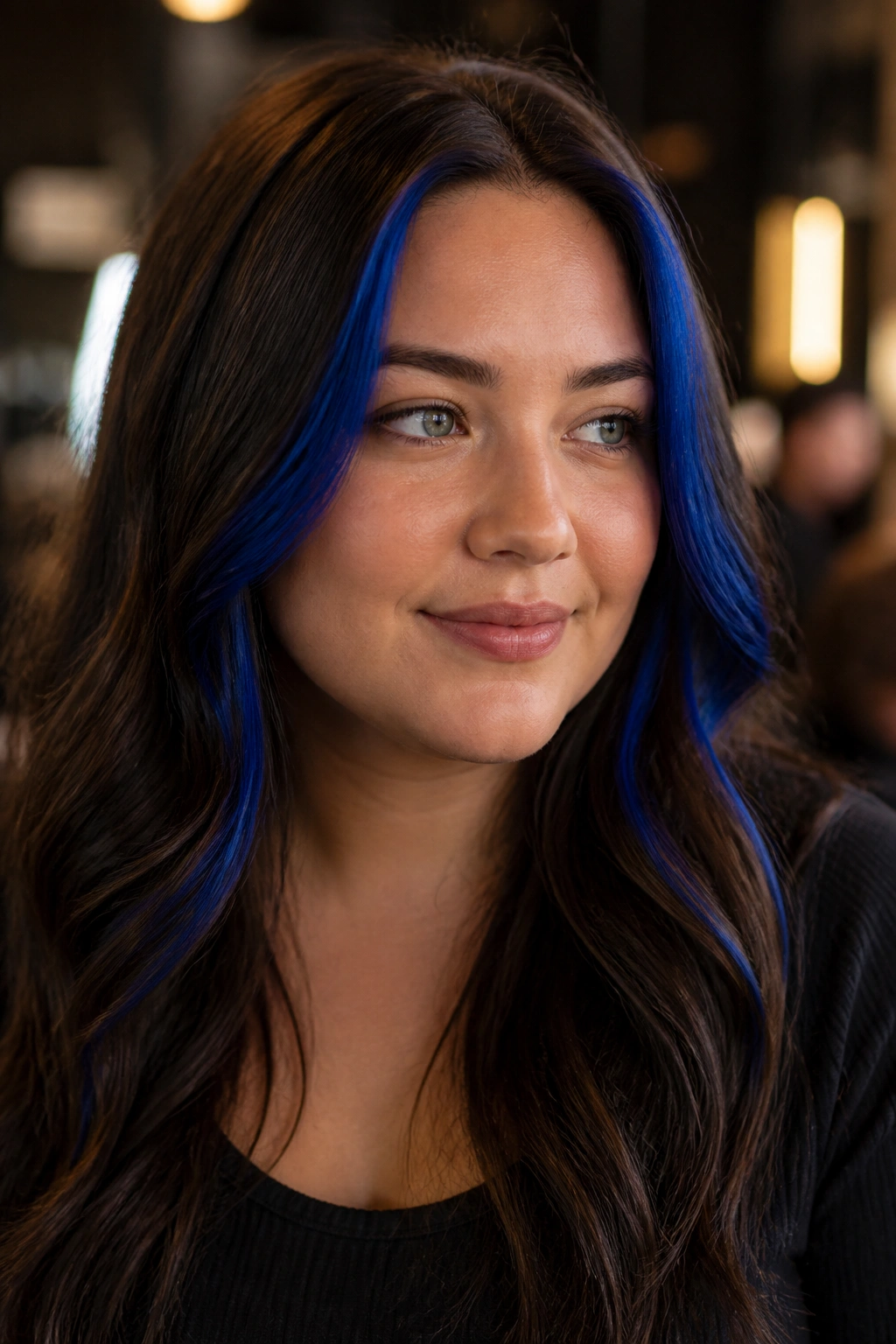 Real person with chocolate brown hair featuring high cobalt money pieces at the front for a slimming effect.