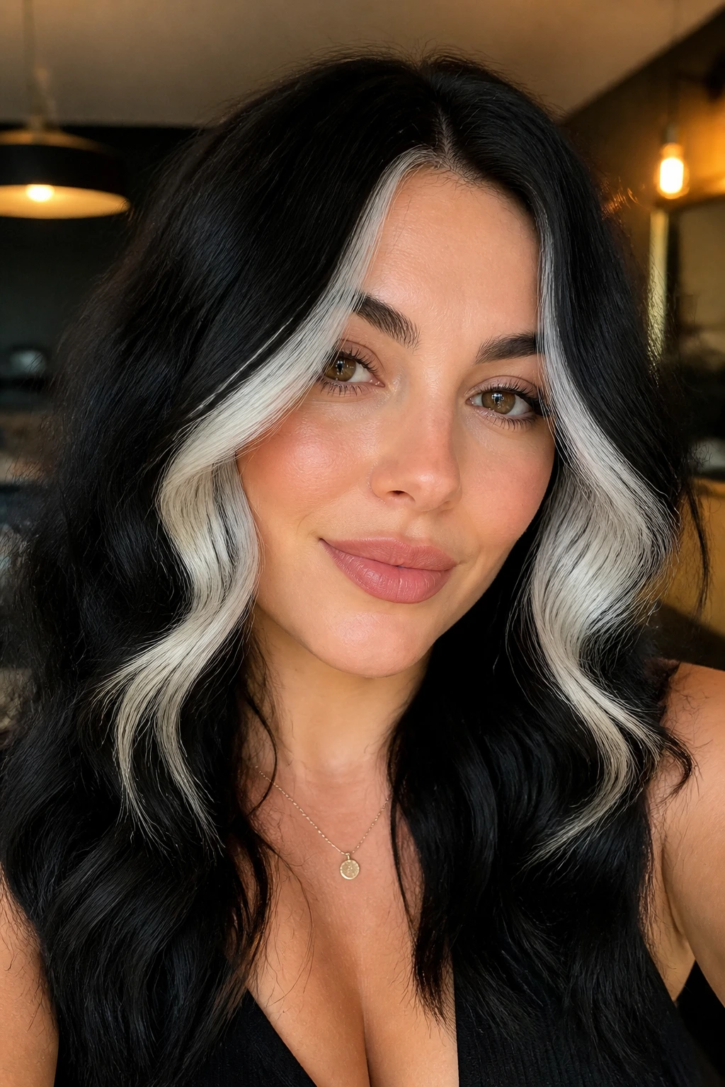 Portrait of a person with white panels framing the cheeks in black hair