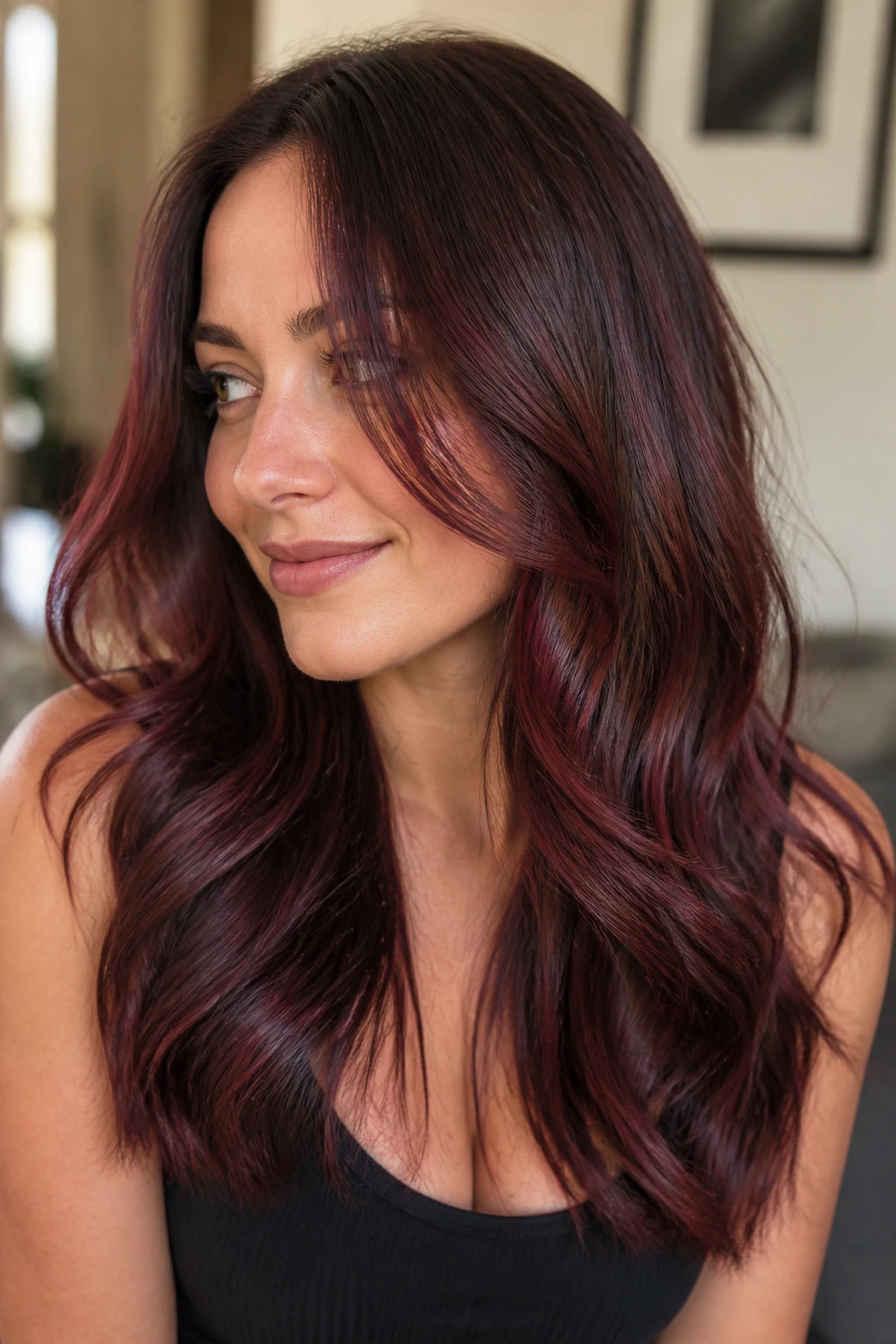 Close-up of a real woman with brown base and claret lowlights for dimension