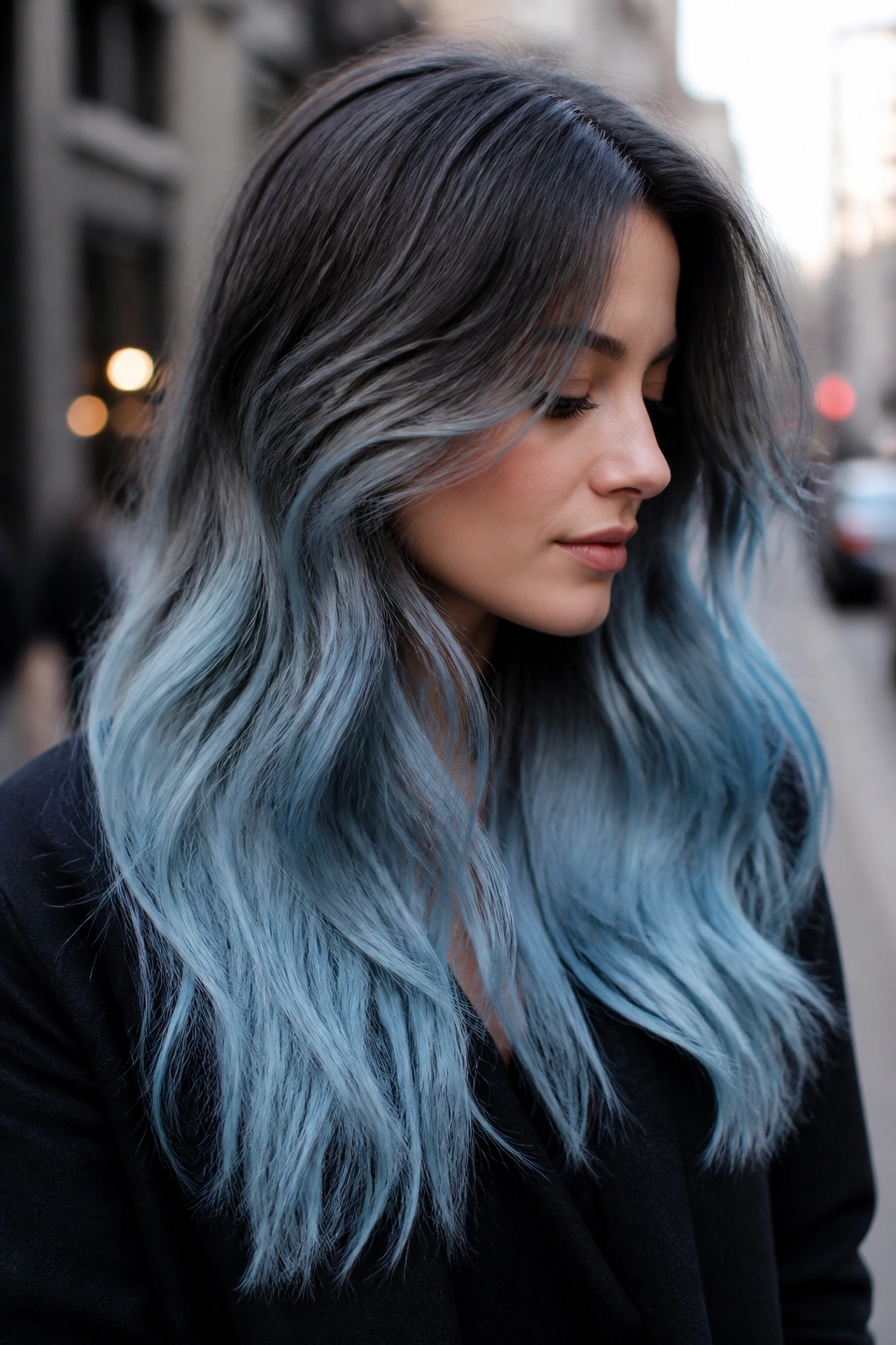 Close-up portrait of a real person with cloudy blue ombré hair fading from roots to ends