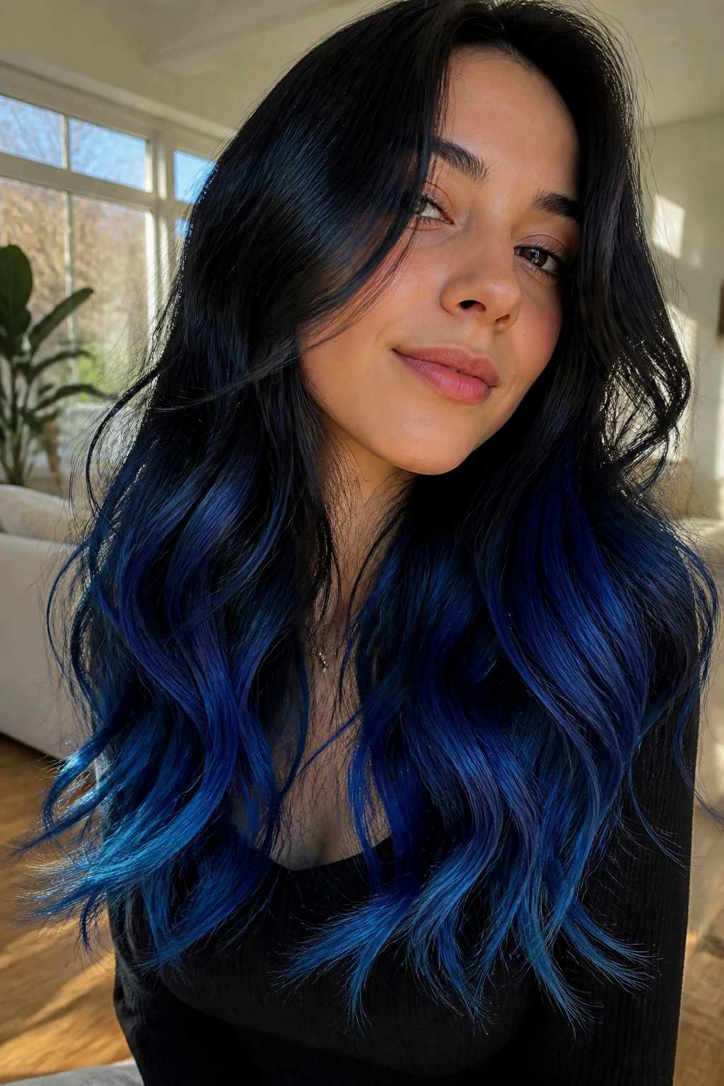 Woman with black hair and cobalt blue ends in loose waves.