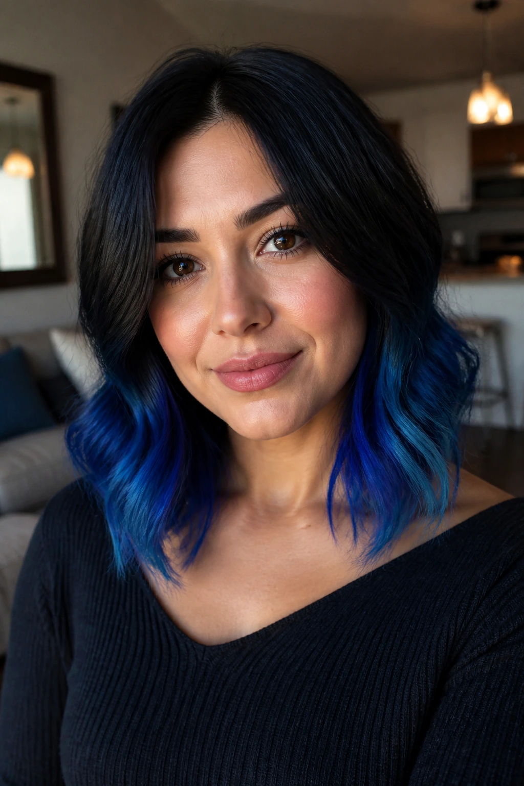 Close-up portrait of a woman with cobalt ombre starting below the chin on shoulder-length wavy hair