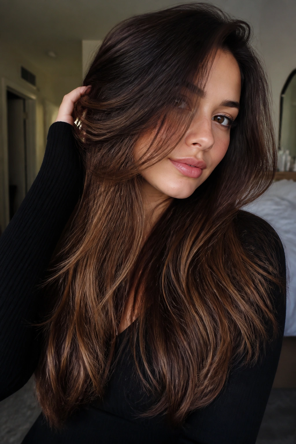 Close-up of a real woman showing hidden underlayers in cocoa brunette hair