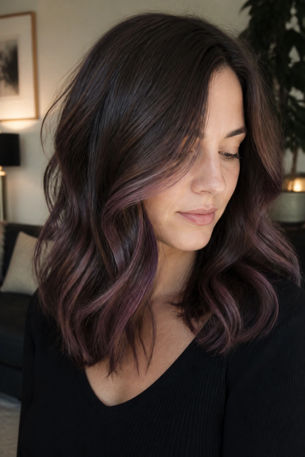 Shoulder-length cocoa plum balayage on a real person with plum pieces starting below the cheekbone