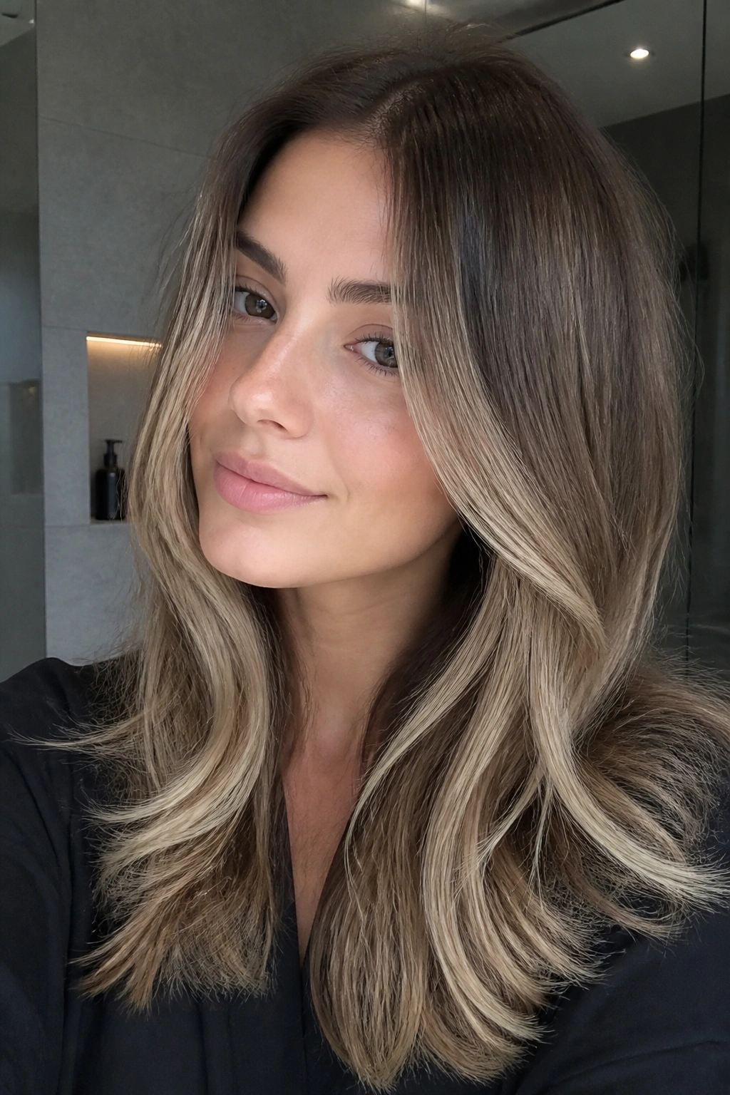 Close-up of cool ash brown balayage with vanilla ends on a real person