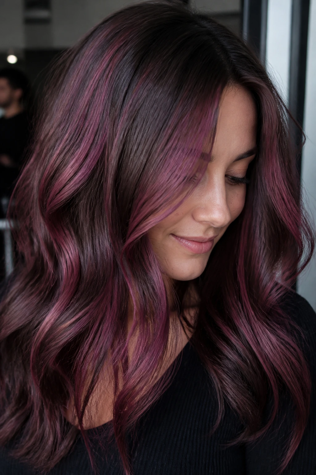 Close-up of ash brown hair with cool burgundy violet-pink highlights around the face.