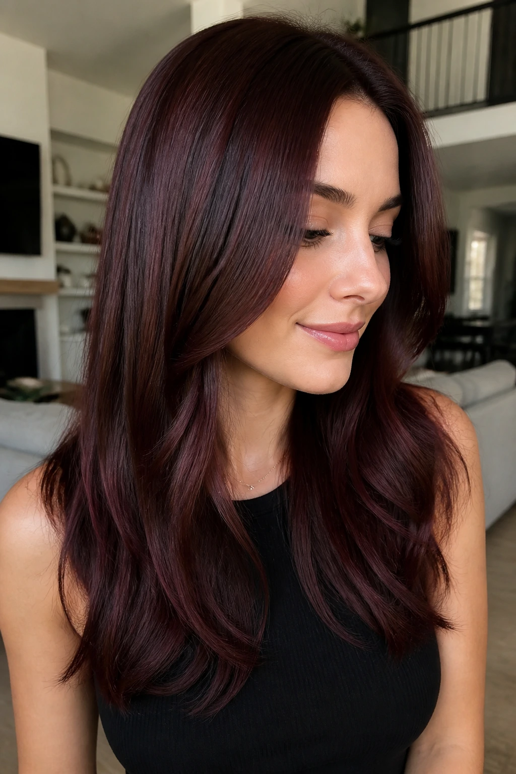 Real person with brunette base and cherry cola burgundy gloss hair in natural light