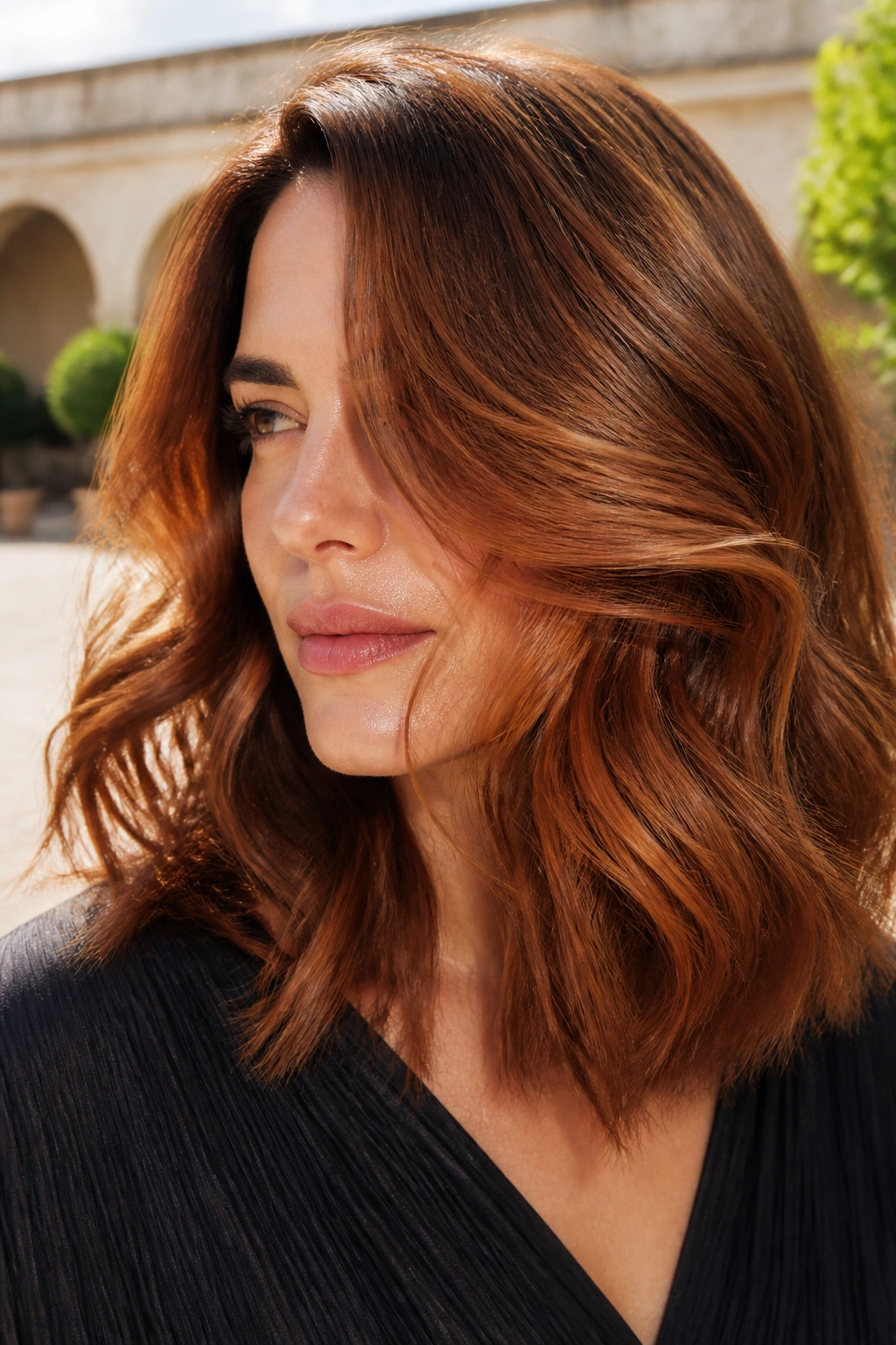 Shoulder-length copper brown brushed-out waves close-up