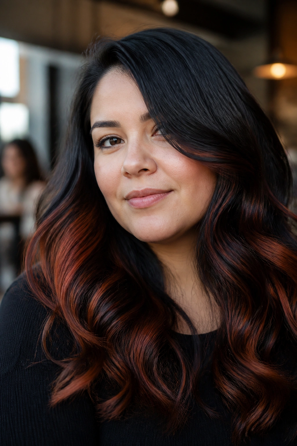 Close-up of a real woman with black waves and copper-red highlights along the lower half