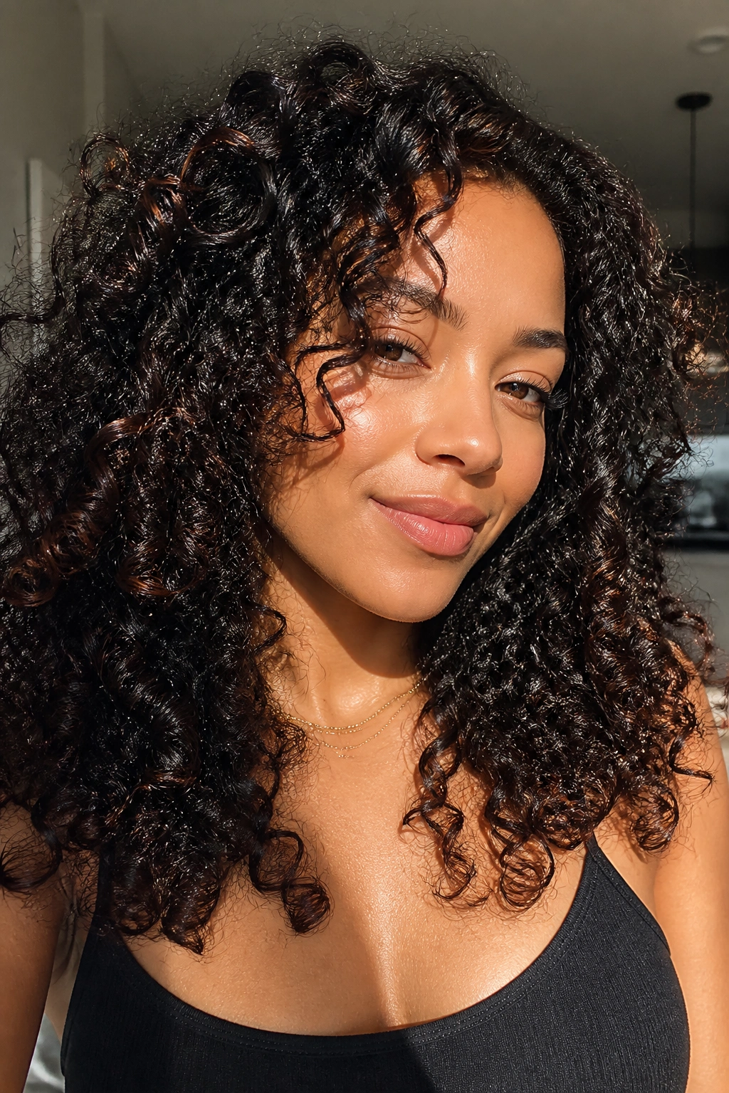Real woman with black curls showing copper sheen in sunlight