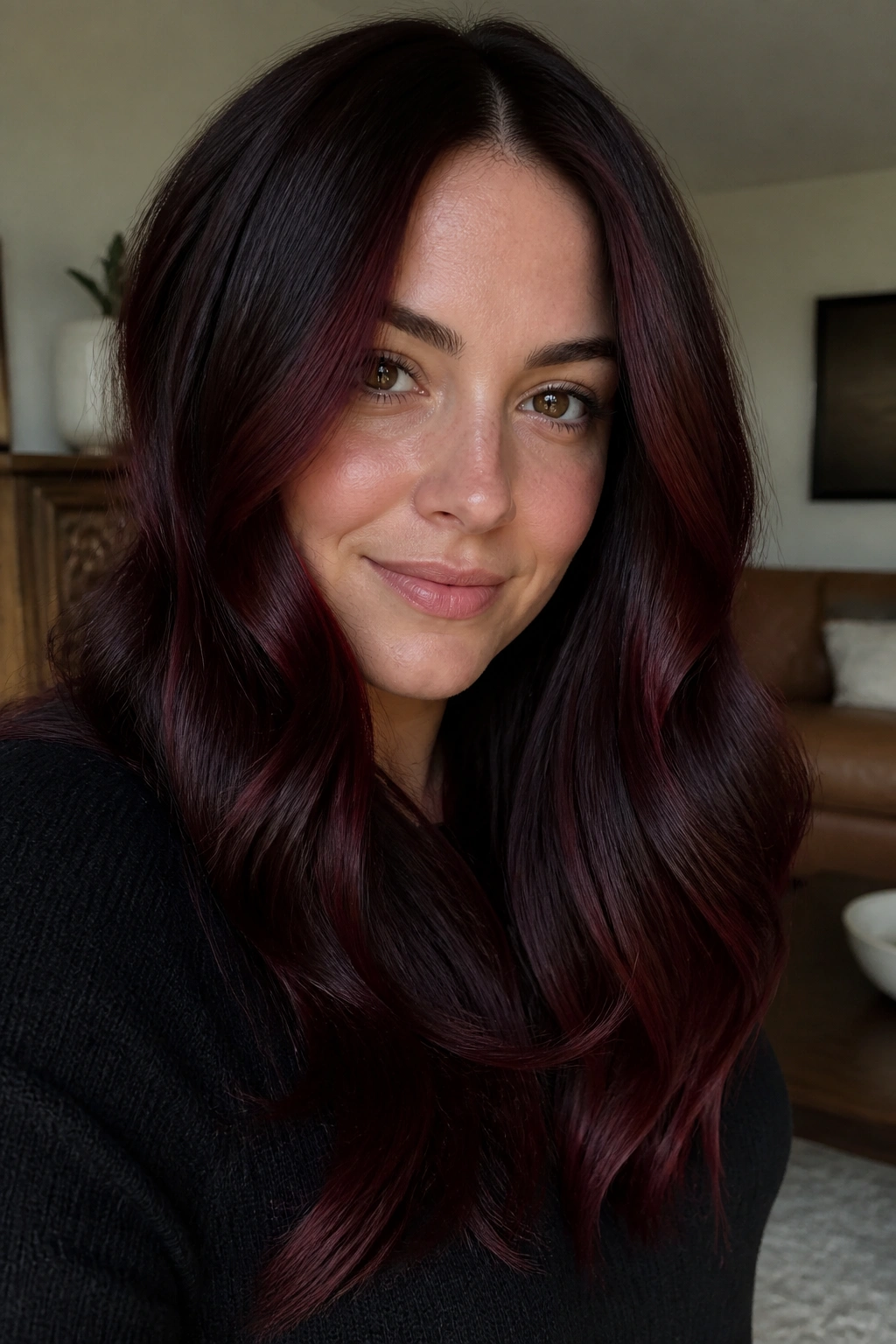 Close-up of a woman with cranberry glaze over dark brunette base.