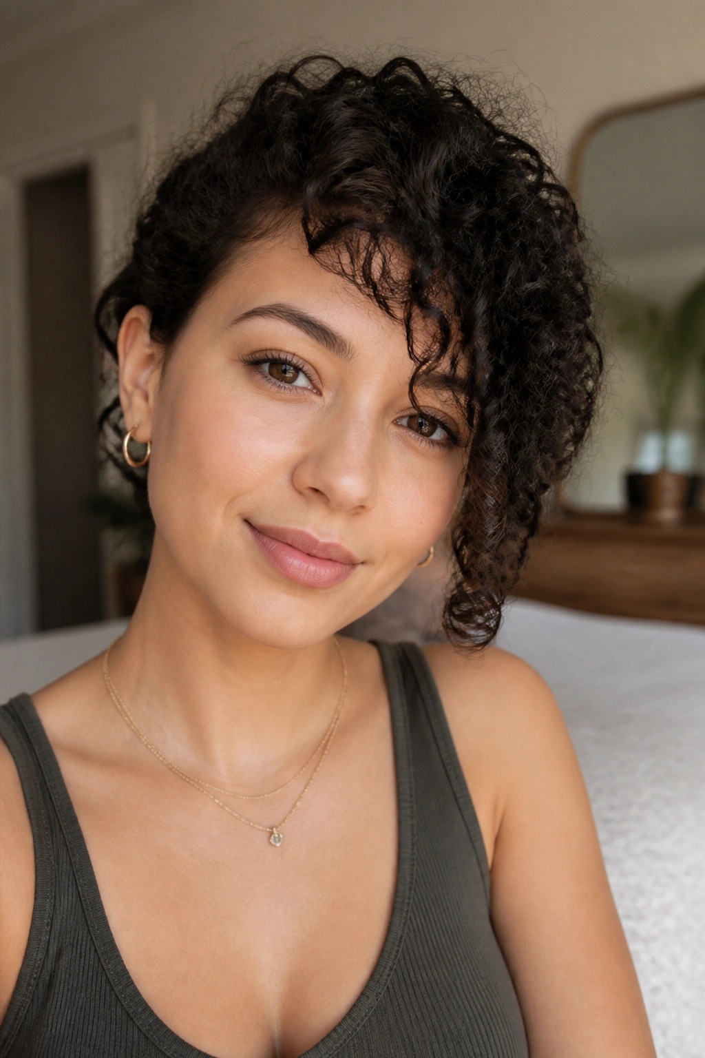 Close-up portrait of a real woman with curly side bangs following the curl bend