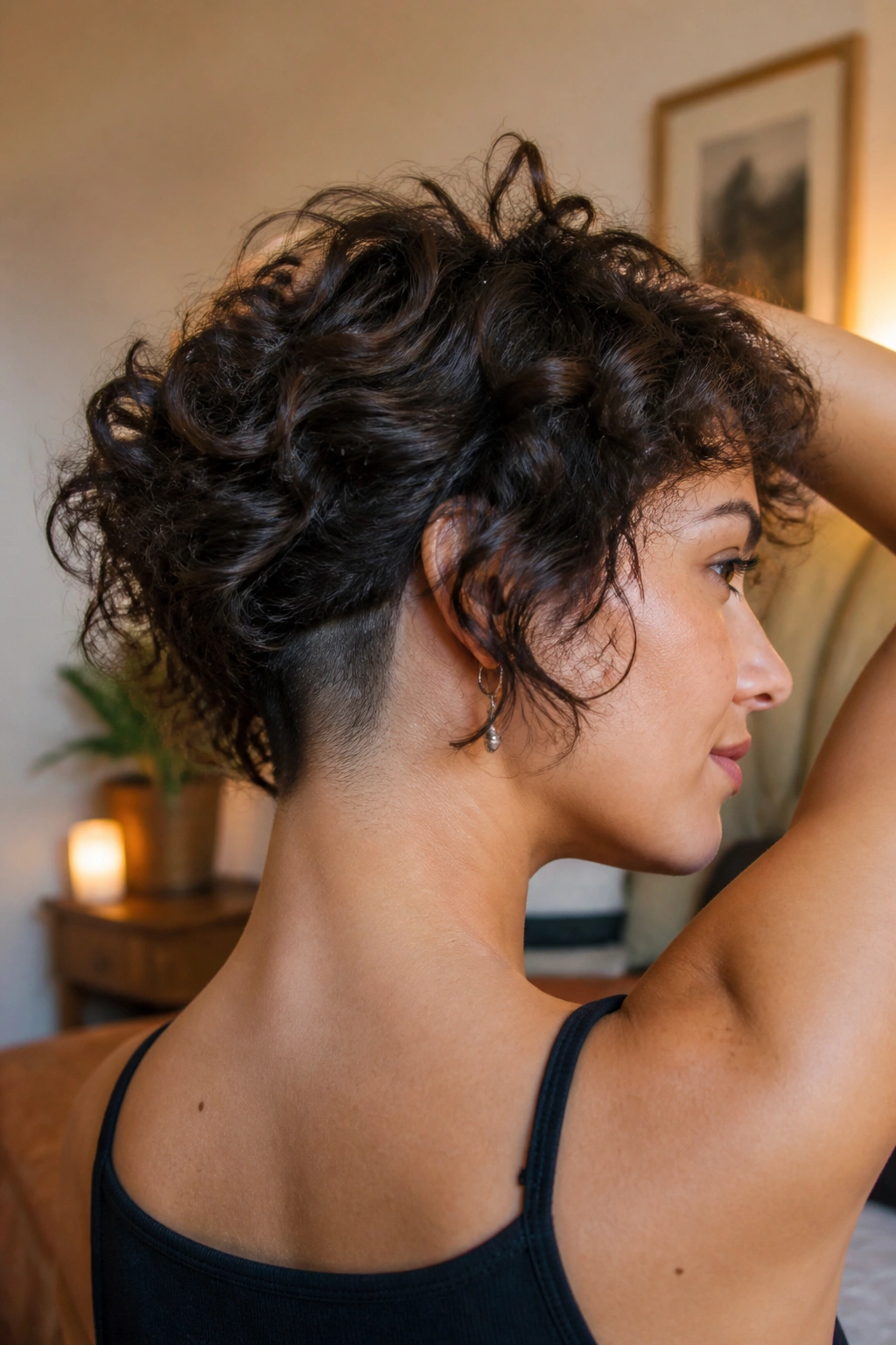Close-up of a real person with curly hair and a subtle shaved nape under curls.