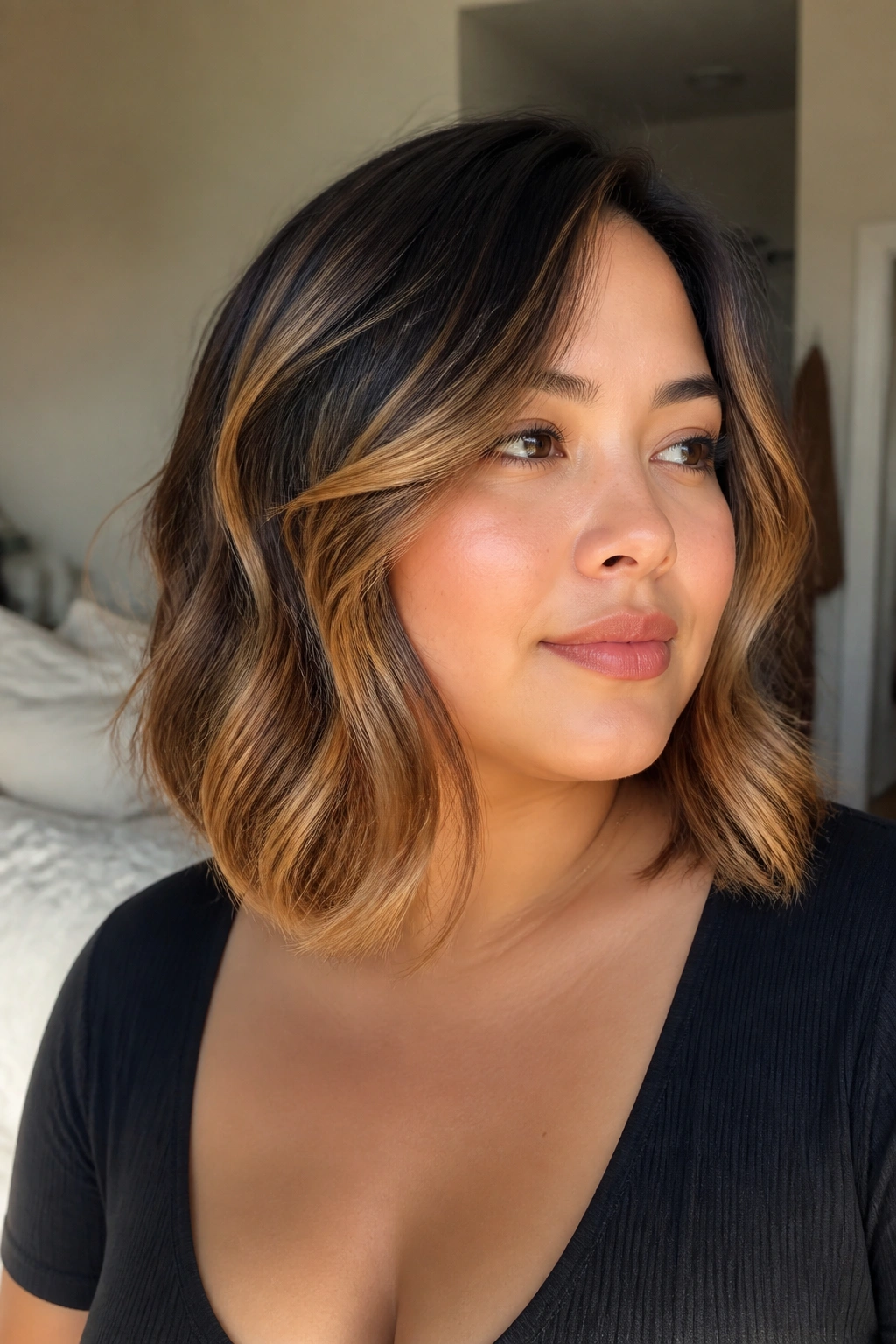 Close-up portrait of a real woman showing curved balayage along the jawline in honey caramel tones