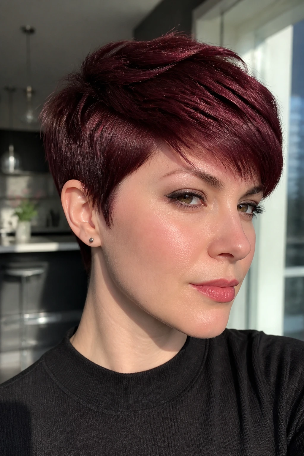 Close-up of a real person with a dark cherry pixie haircut