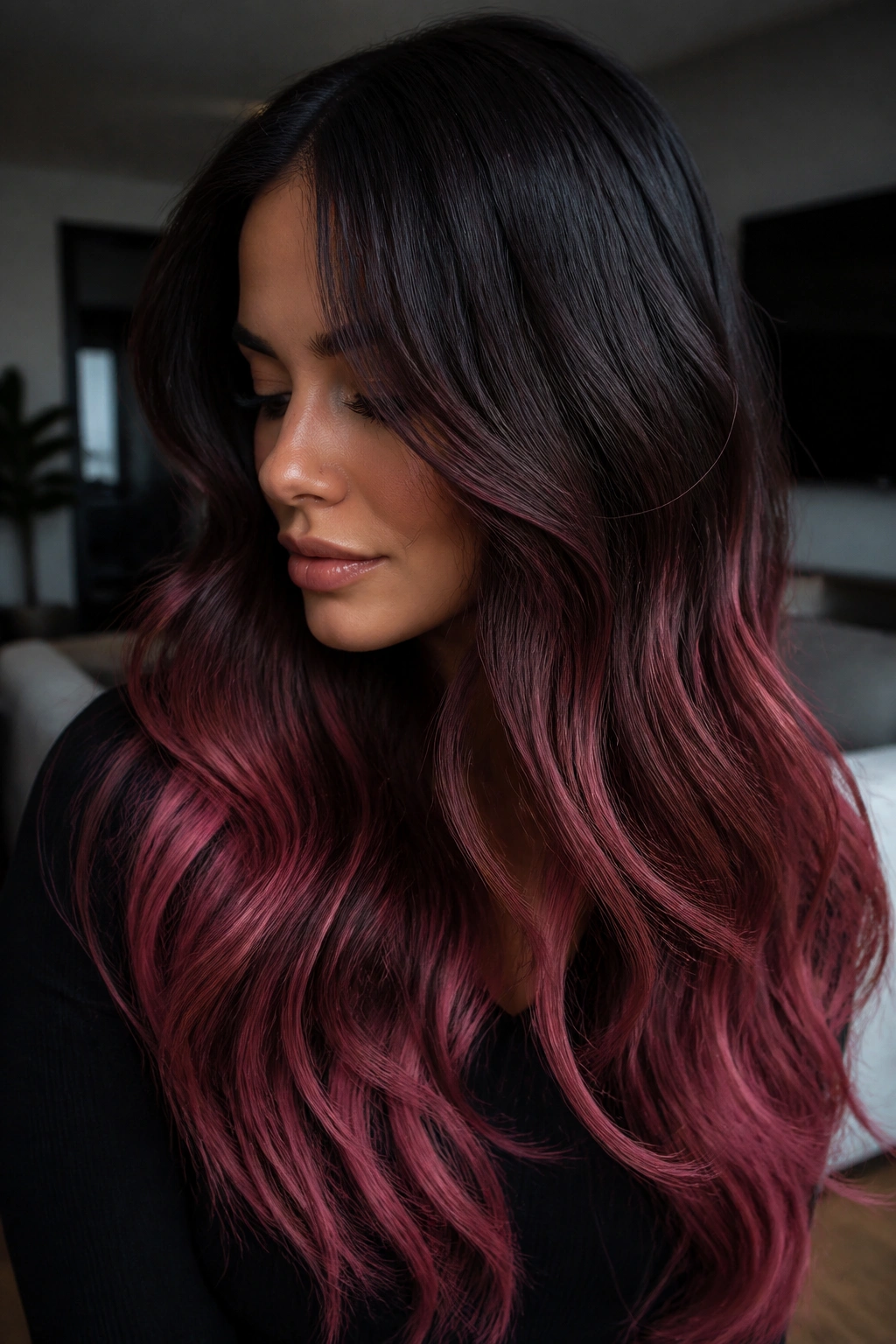 Close-up portrait of deep brunette with plum-rose ends on long hair.