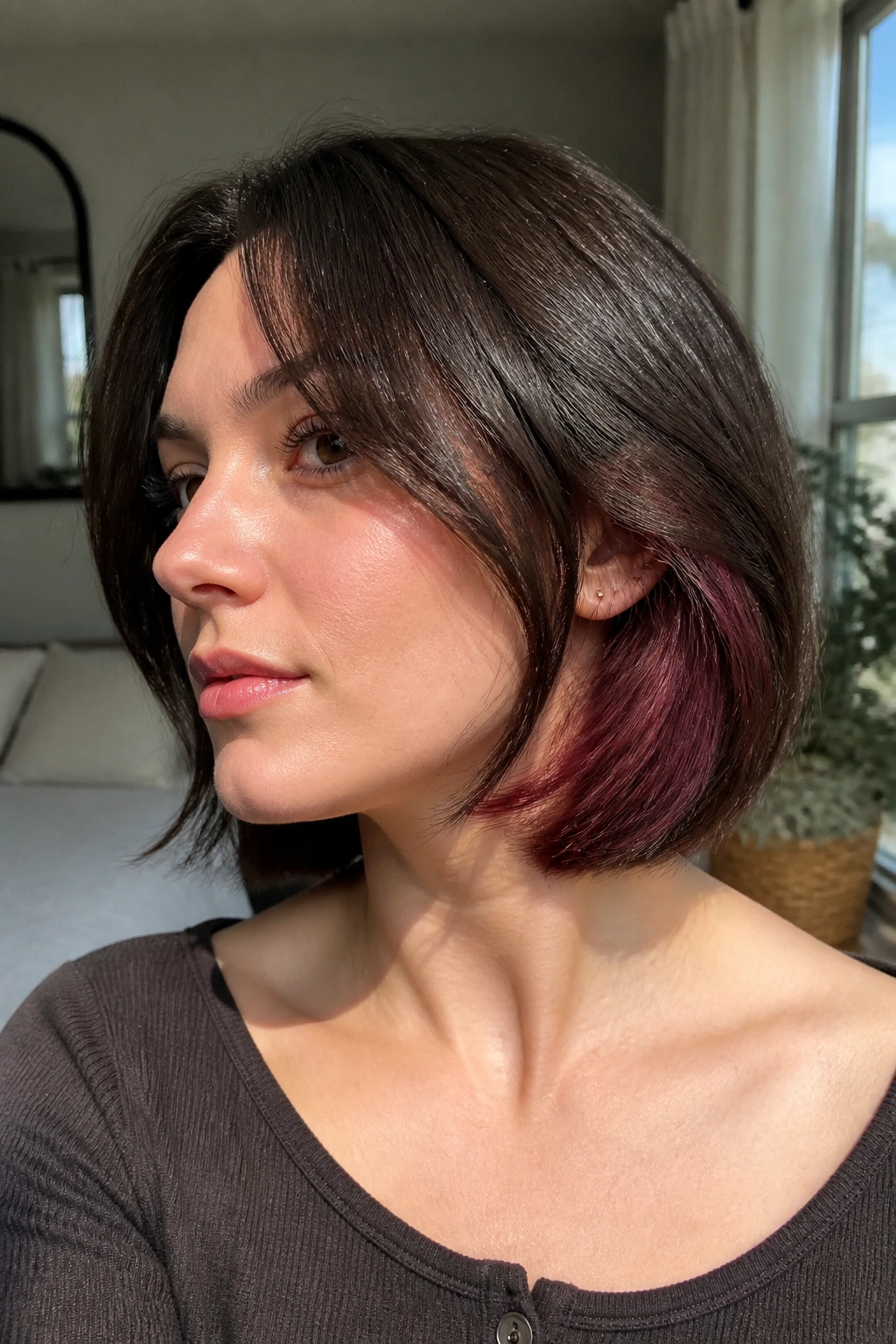 Close-up portrait of a real woman with deep cocoa bob and blue-based cherry peekaboo