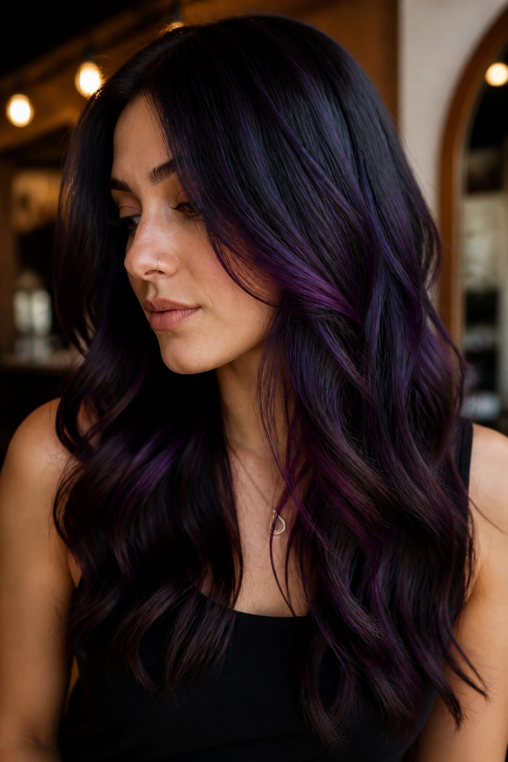 Portrait of a person with deep grape color on black-brown hair in warm indoor light