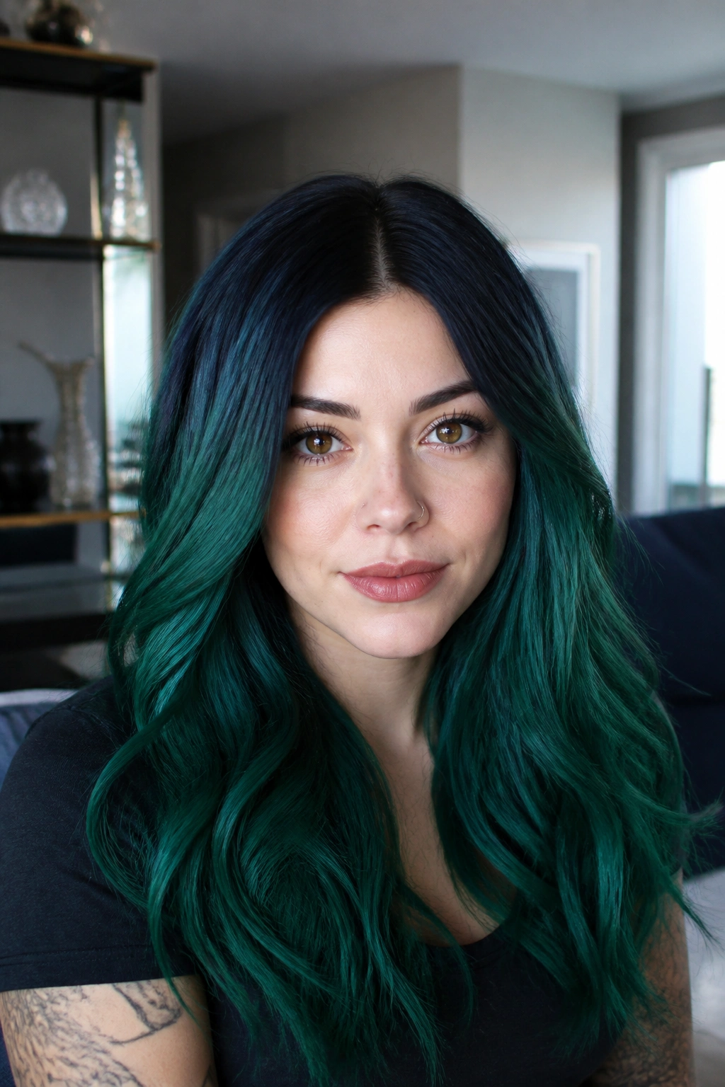 Portrait of a person with deep jade hair and navy roots in a cool room