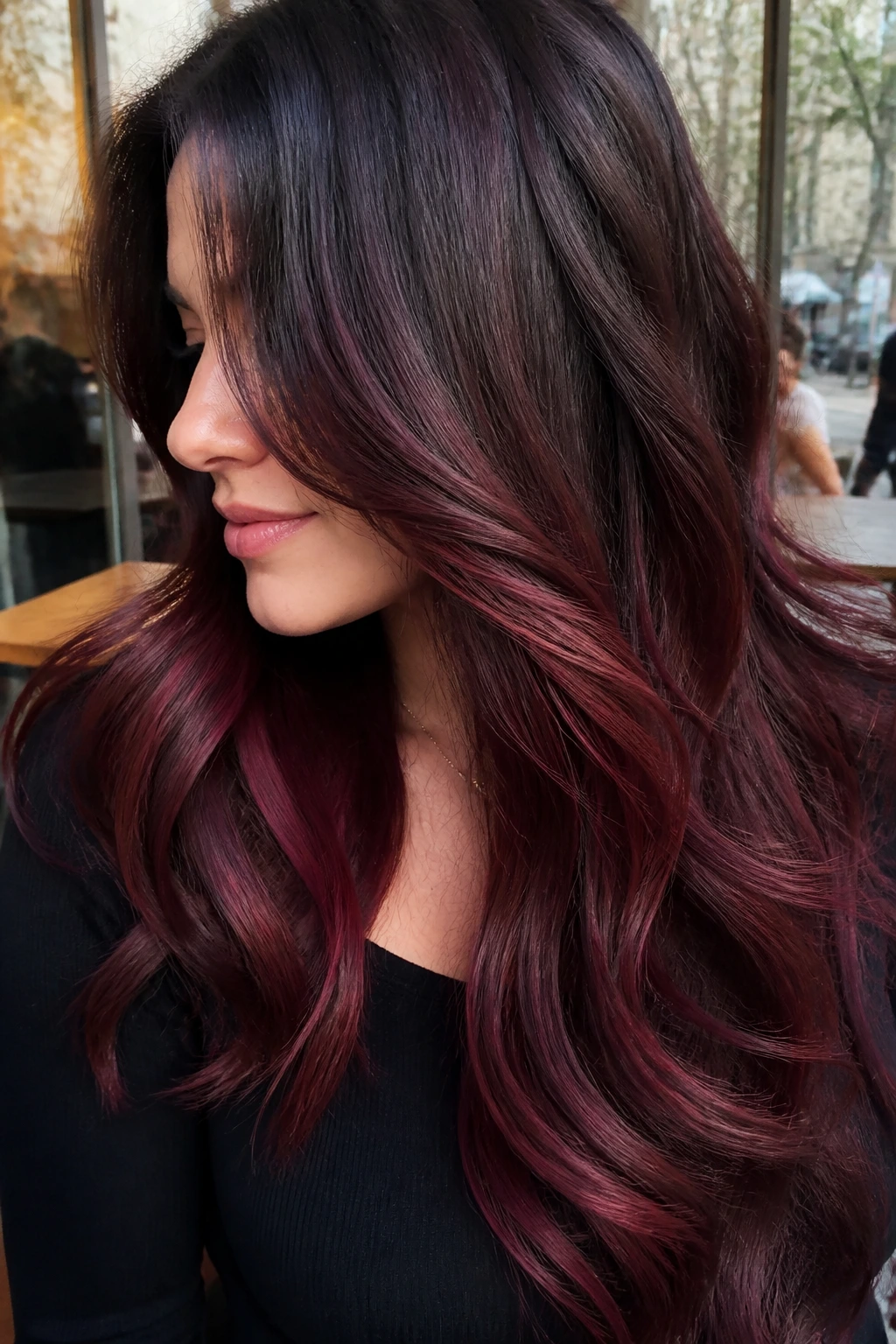 Long brunette hair with deep sangria panels in interior and lower lengths.
