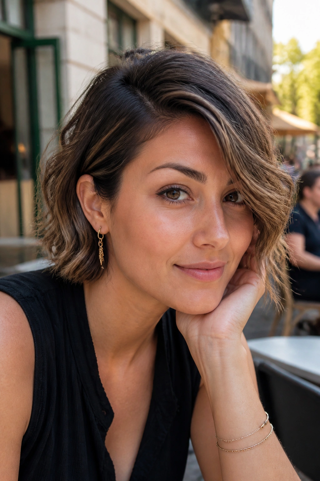 Portrait of a real woman with a deep side part and wavy crop.