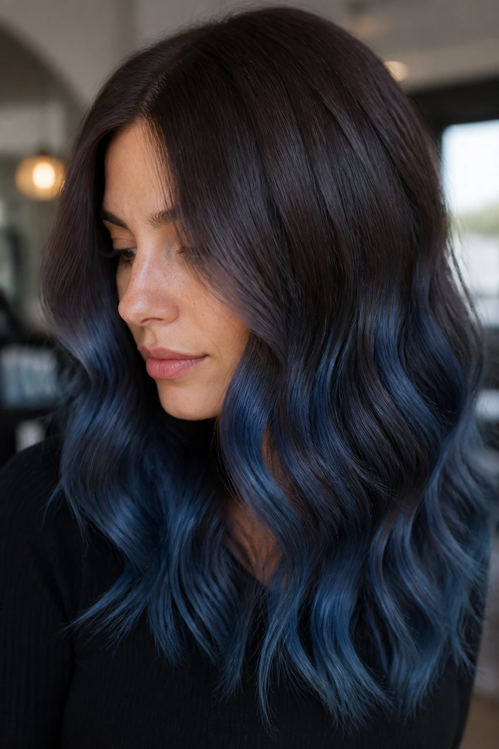 Chocolate brown hair with denim blue melt balayage.