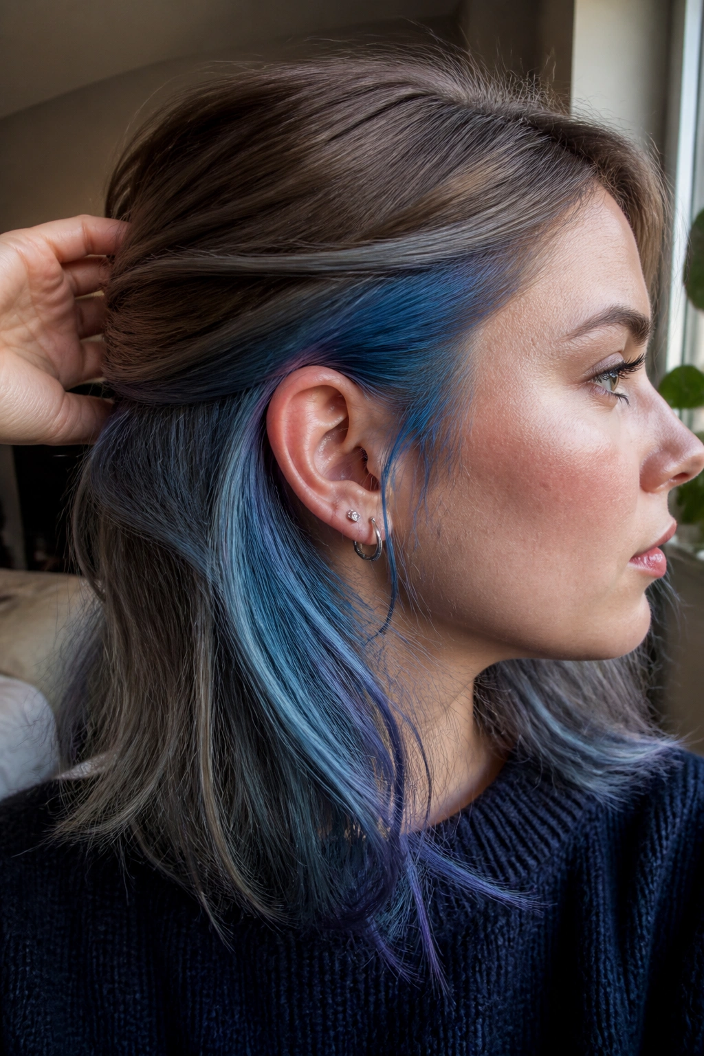 Close-up of hair with pastel denim underlayer peeking from beneath the top layer.