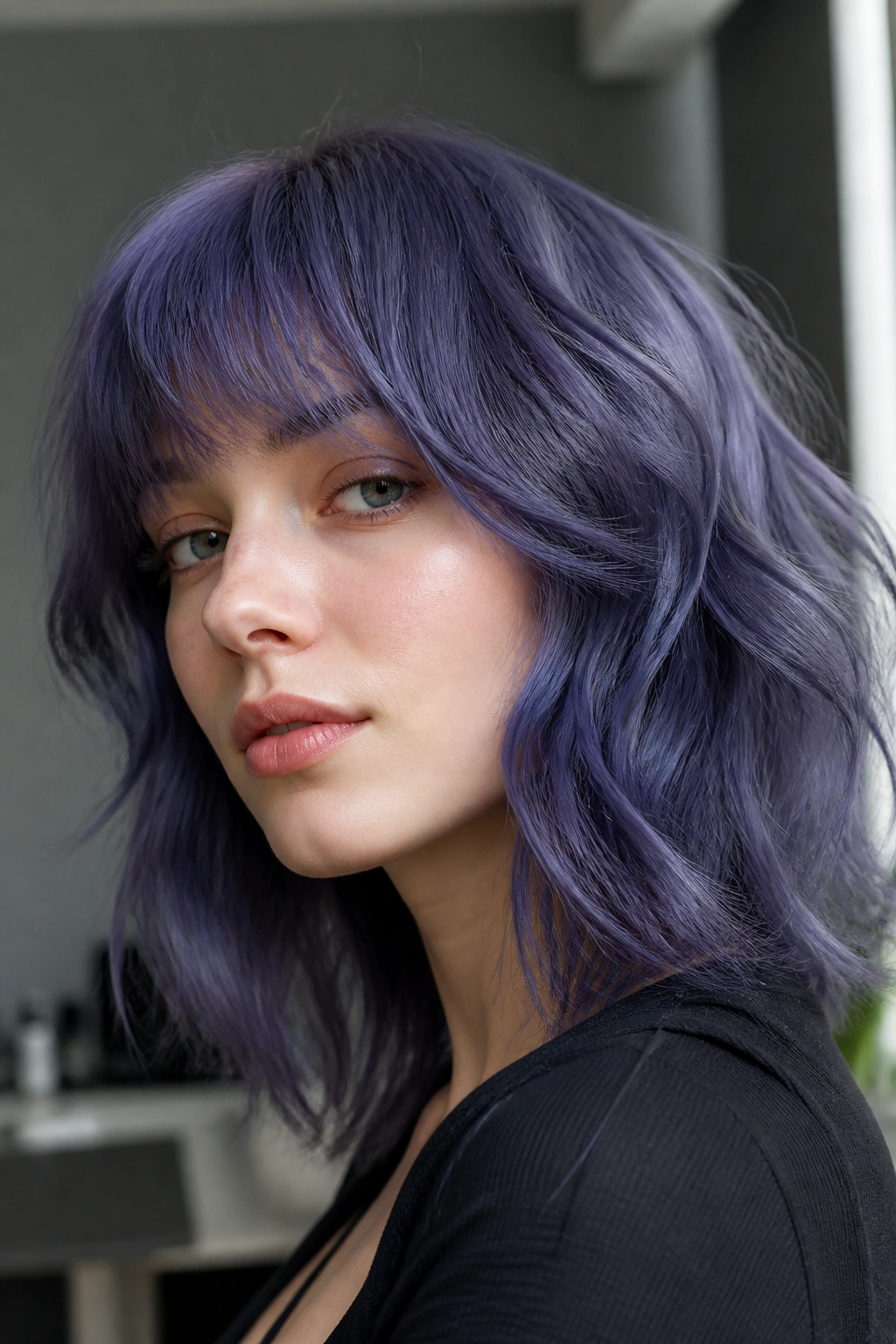 Close-up of a person with denim violet hair in a cool-toned interior