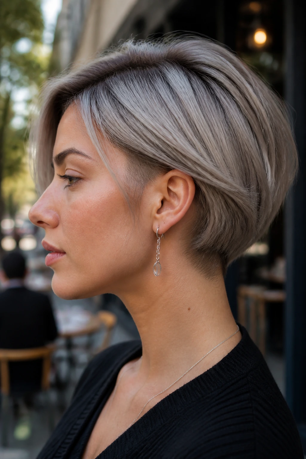 Real woman with disconnected ash bob and hidden undercut viewed from the side.