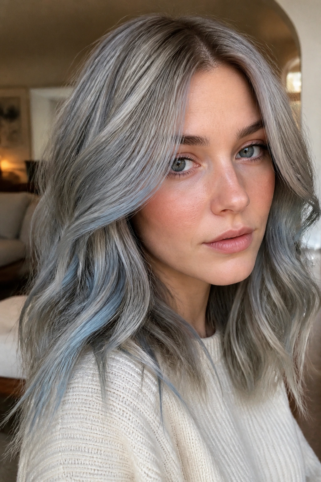 Portrait of a real person with dusty blue mushroom blonde in warm interior lighting