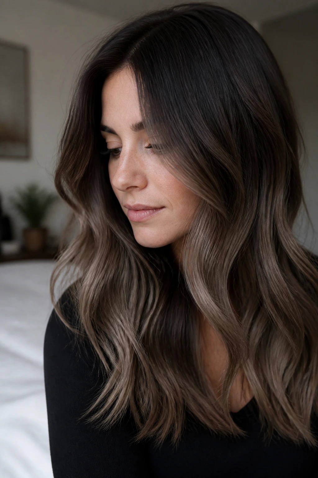 Close-up portrait of a real woman showing Dusty Cocoa Ombré hair color with dark roots fading to dusty ash-brown ends