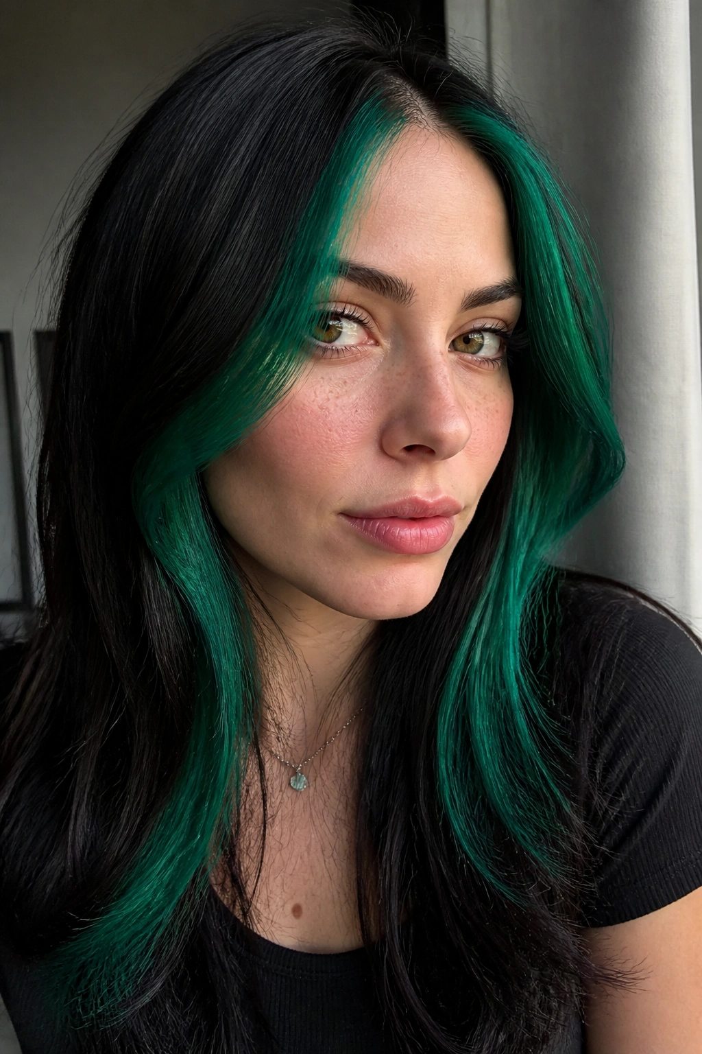 Close-up of a person with emerald money piece framing the face