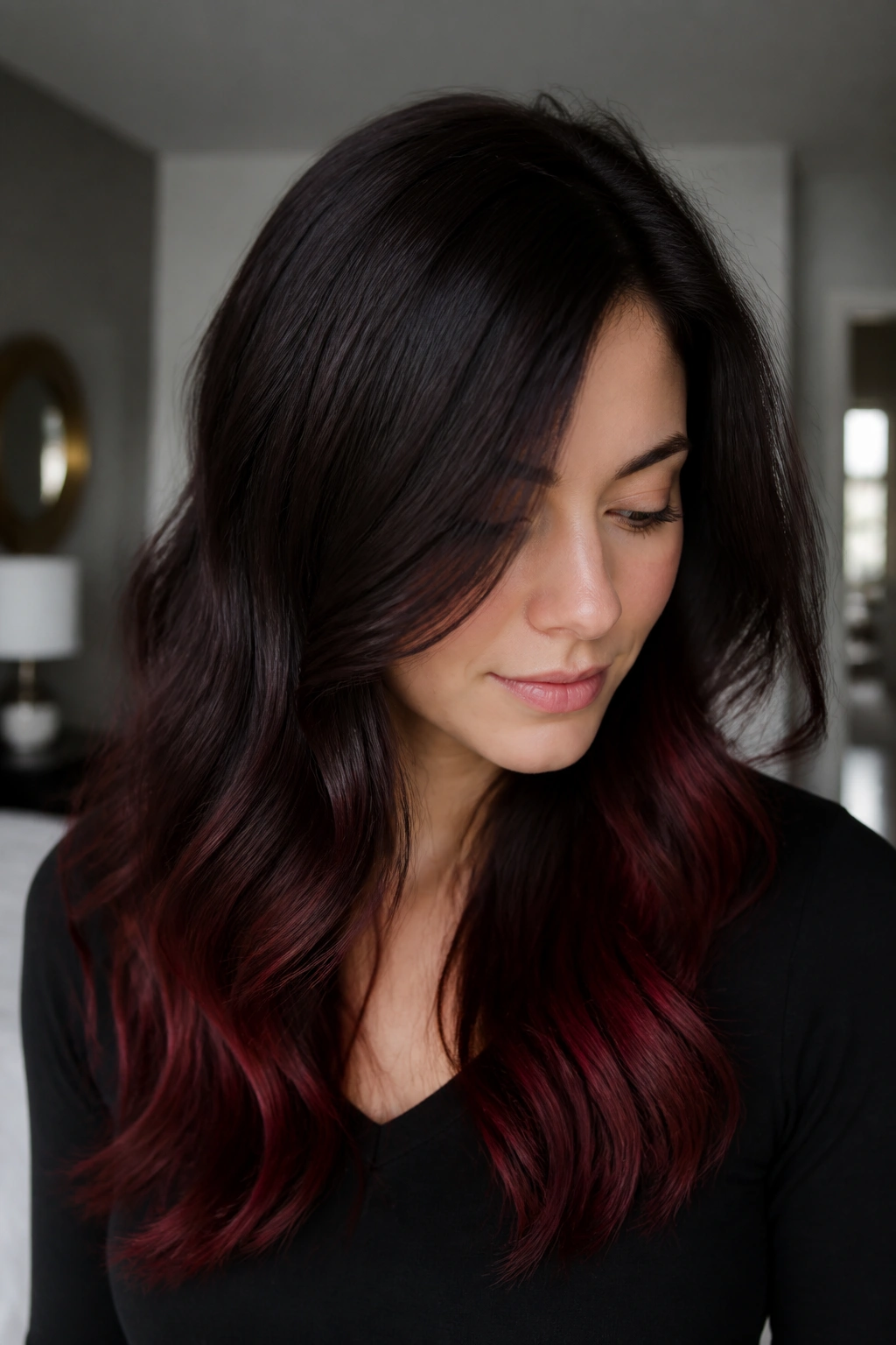 Close-up portrait of a real person with espresso auburn and red gloss on cool skin.