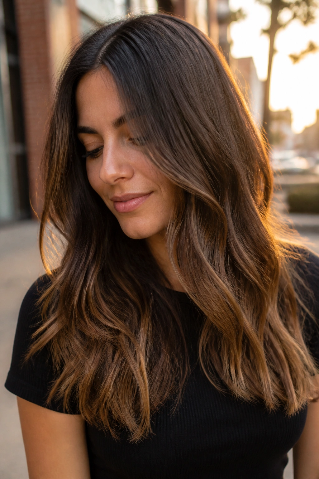 Close-up of espresso brown hair with soft hazelnut ends on a real person.