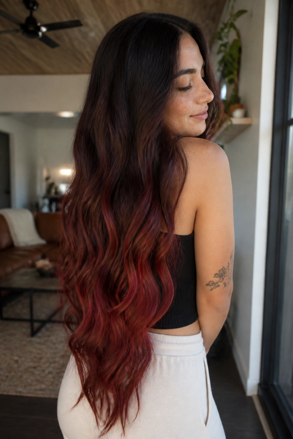 Close-up of waist-length hair with espresso to red melt on a real person, soft window light.