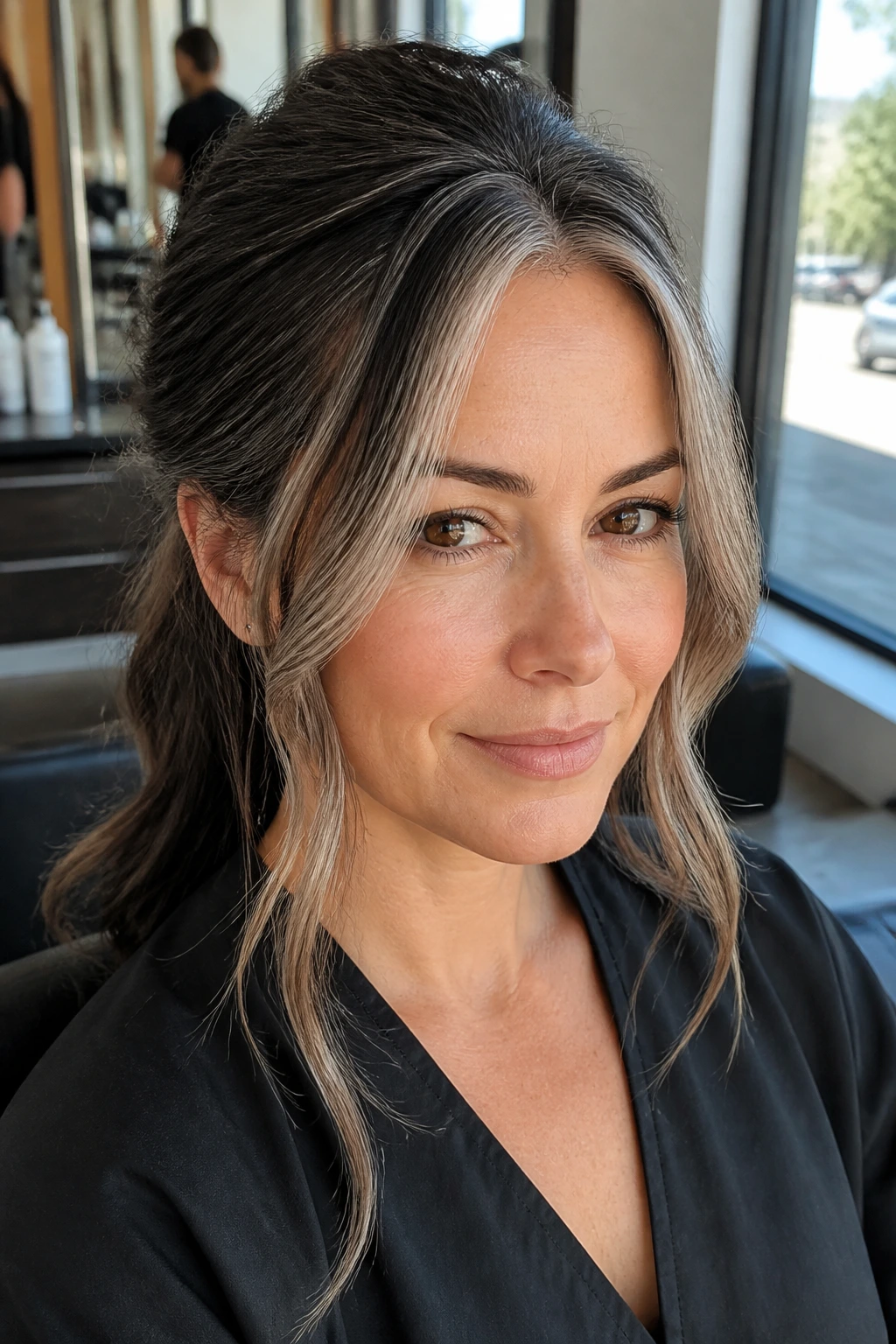 Close-up of real woman with face-framing gray and beige front highlights