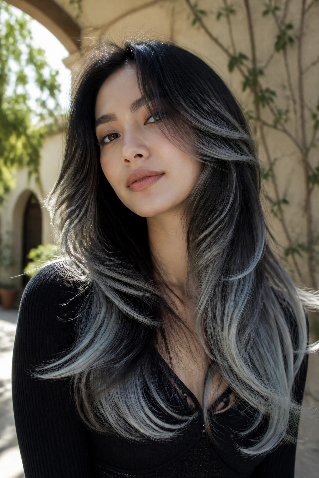 Portrait of a real person with feathered layers and silver dust on long hair.