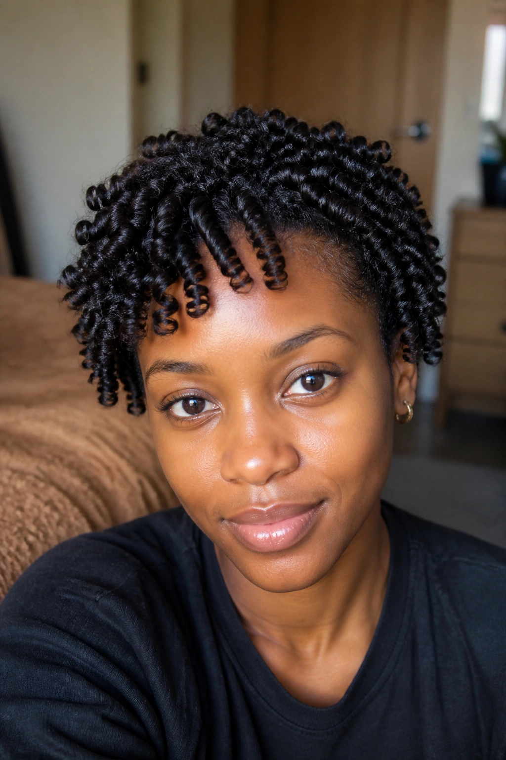 Close-up of a real person with finger coils showing tight, glossy spirals