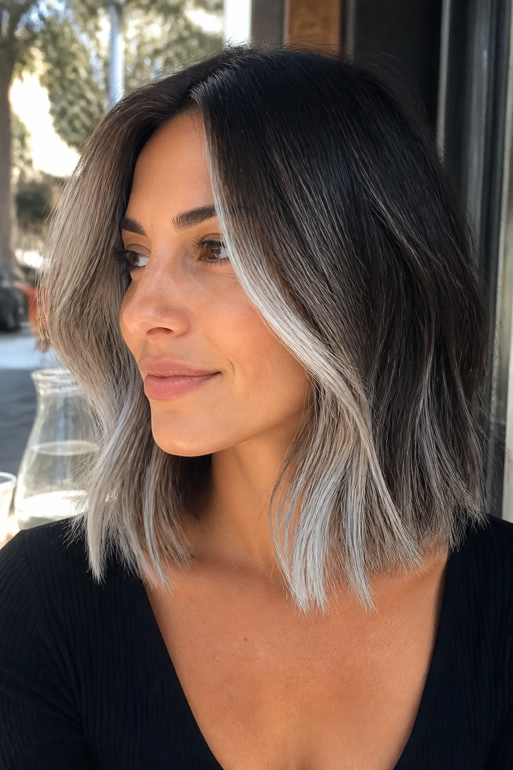Close-up of a real woman with silver foilayage on a shoulder-length lob