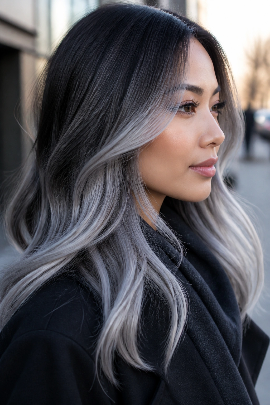 Portrait of a woman with frosted icy silver balayage on mids and ends