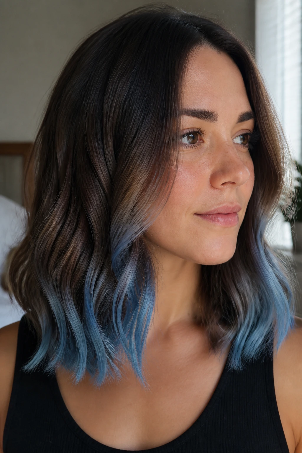 Close-up of a woman with a frosted blue tips on a wavy lob hairstyle.