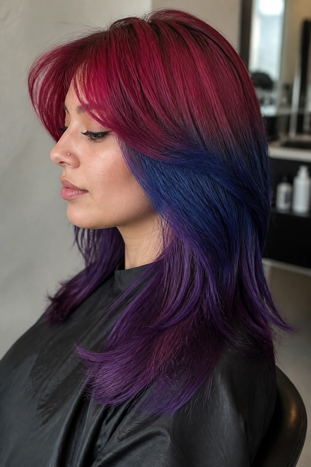 Portrait of a real person showing Frosted Cherry, Blueberry, and Plum color panels on layered hair.