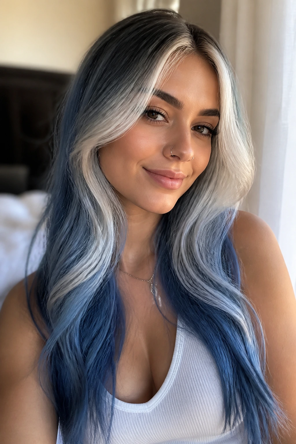 Close-up of a real woman with frosted face-framing ombre and blue melt on long hair